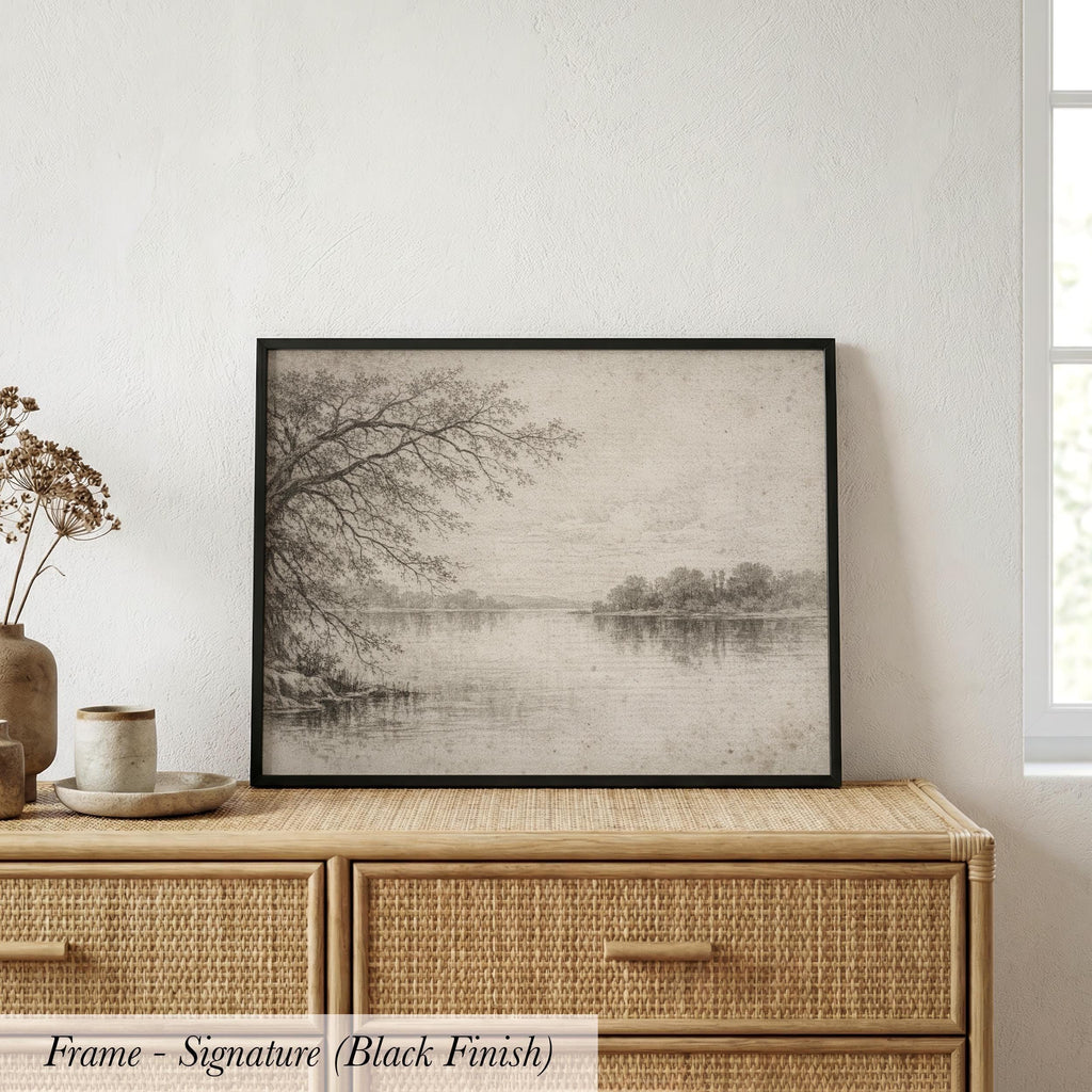 a black and white landscape painting hanging on a wooden dresser.