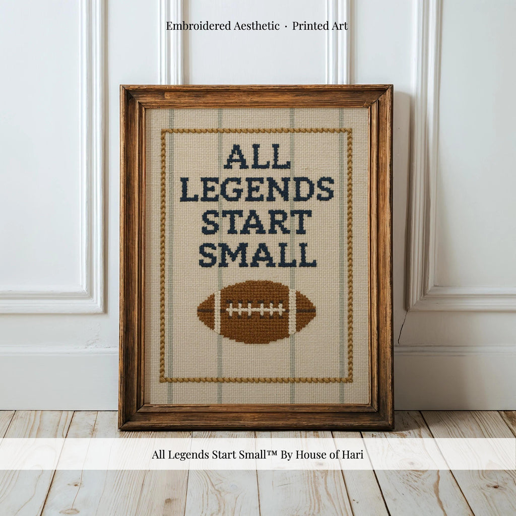 a framed embroidered cross-stitch design with the text "ALL LEGENDS START SMALL" and a football motif.