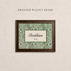 May include: A rectangular bronzed walnut frame containing a print with a green and cream floral pattern. The center features a cream rectangle with a dark green border, displaying the text Beckham and the smaller text EST. 2004 in black.