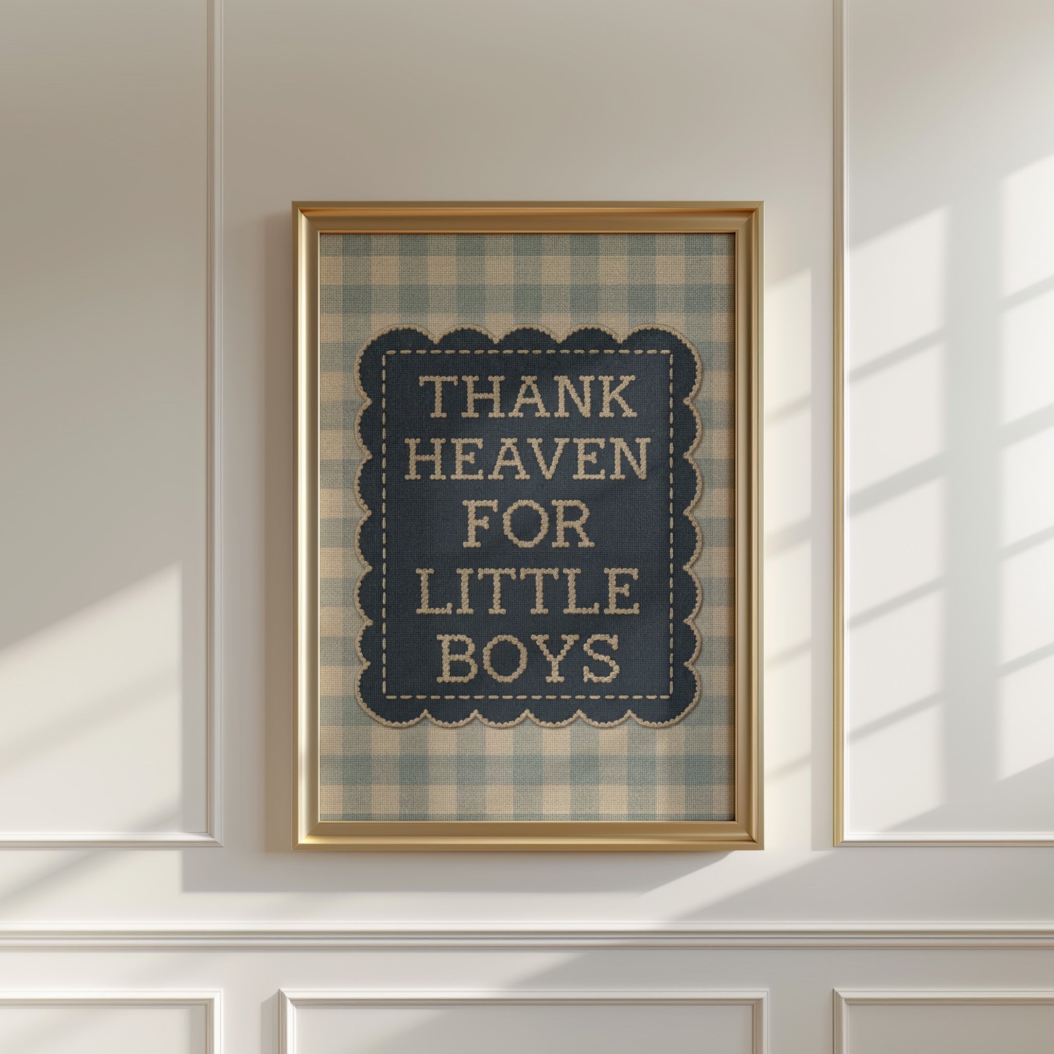 a framed sign with the text "THANK HEAVEN FOR LITTLE BOYS" on it, hanging on a white wall.