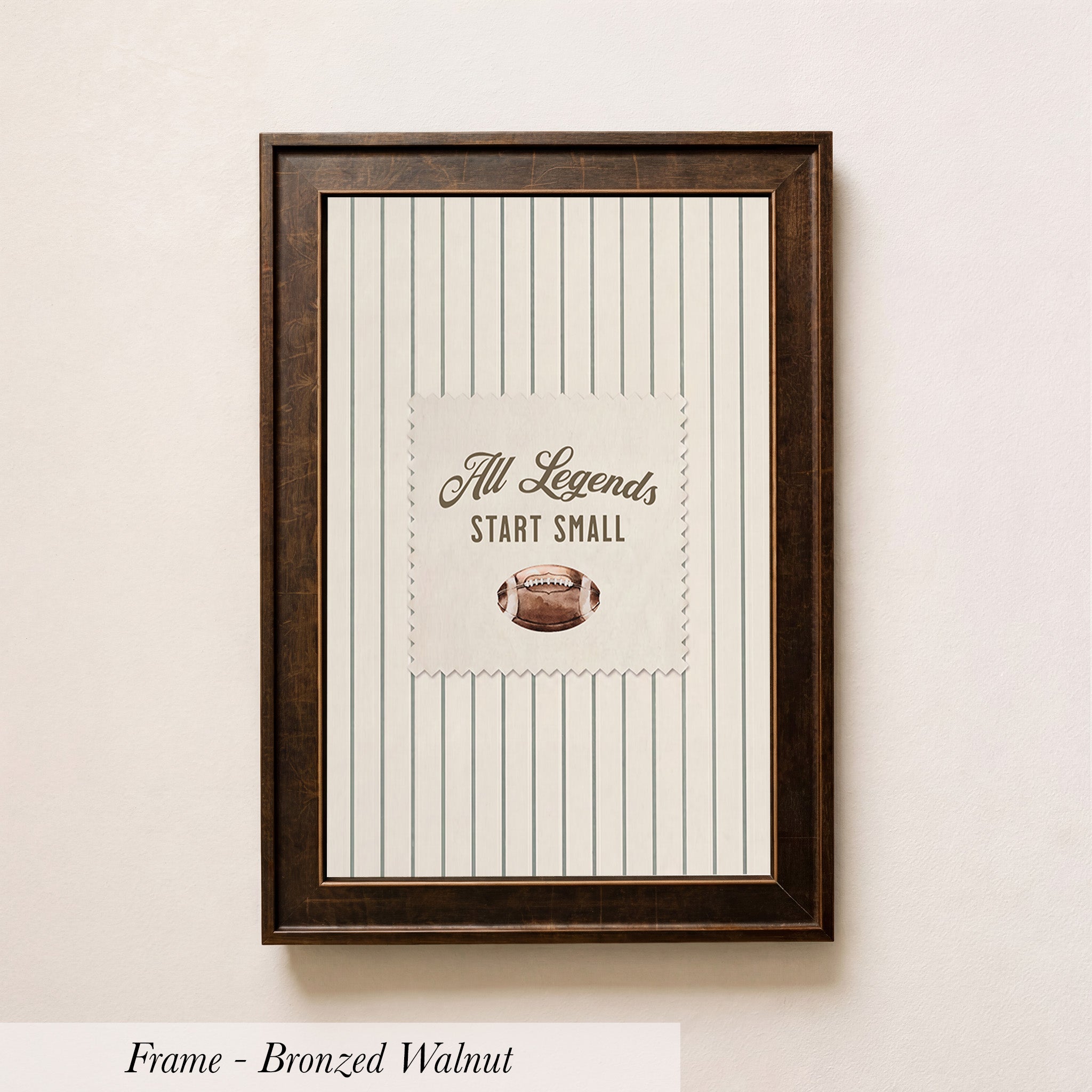 A framed picture with a striped background and a football image in the center, along with the text "All Legends Start Small" displayed on the picture.