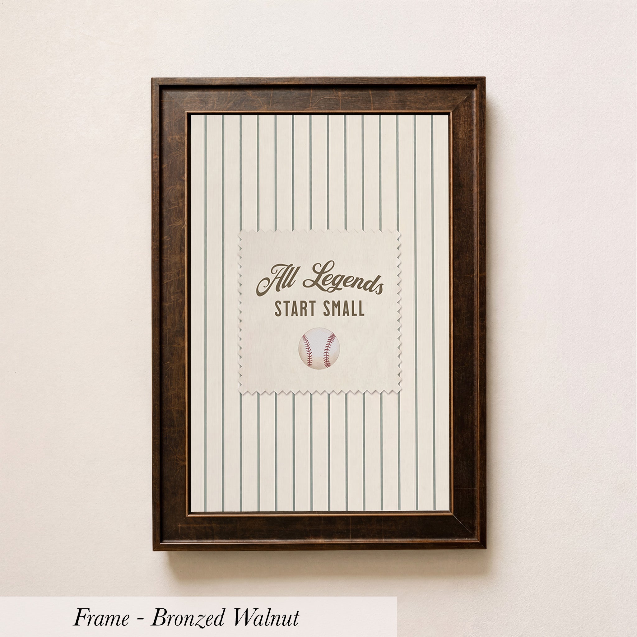A framed picture of a baseball with the text "All Legends Start Small" displayed on it.