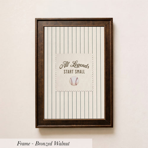 A framed picture of a baseball with the text "All Legends Start Small" displayed on it.