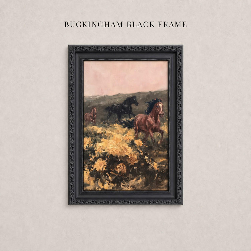 A framed painting depicting three horses galloping through a field with yellow flowers.